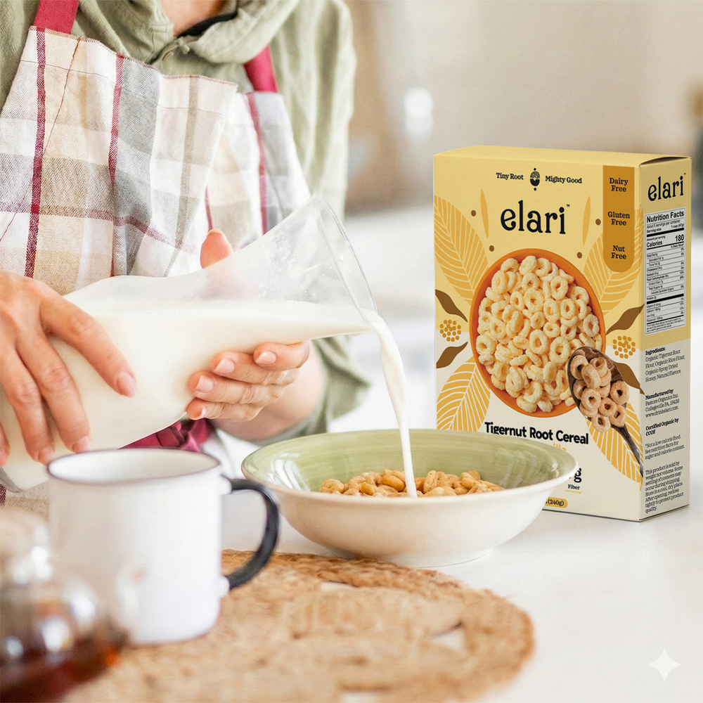 Person pouring milk into a bowl of elari tiger nut root cereal with the product packaging in the background.